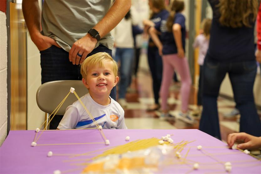 A boy with blond hair smiles